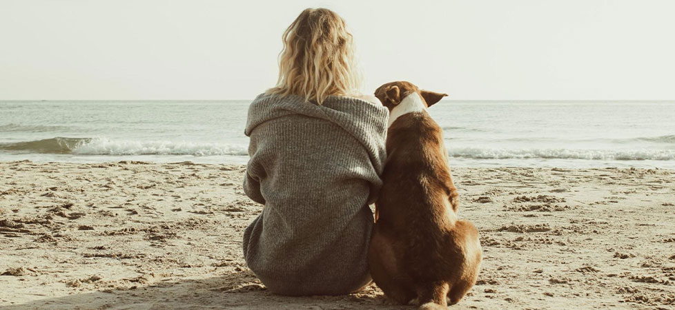 woman and dog at the beach