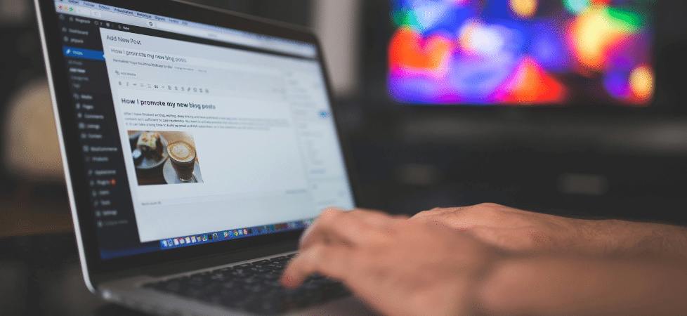 Person typing on a computer, adding a blog to their website